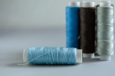 Assorted of colorful thread spools on table, needlework and tailoring concept Stock Photos