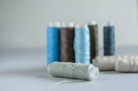Assorted of colorful thread spools on table, needlework and tailoring concept Stock Photos