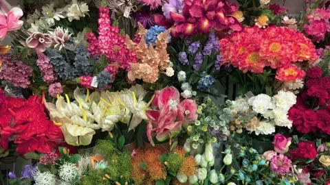 Assorted coloured artificial flowers and stems Stock Footage 240098241