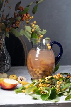 Assorted compote of apples and Japanese quince in a jug, delicious,vitamin drink Stock Photos
