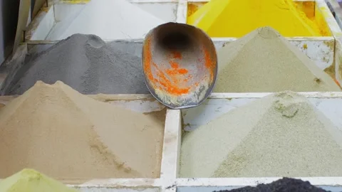 Assorted construction materials, sand, pigments in bins with measuring scoop Stock Footage 344995883