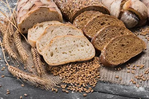 Assorted cookies and bread on a rustic cloth Stock Photos