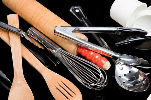 Assorted cooking utensils on black Stock Photos