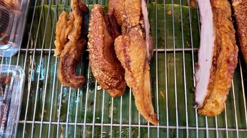 Assorted Crispy Thai Pork Belly Cuts Displayed at Phuket Street Food Market 動画素材 335580854