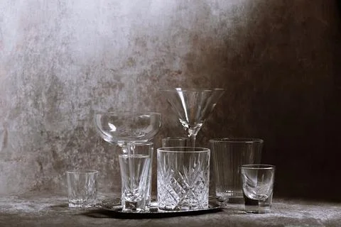 Assorted Crystal Glasses on Textured Surface Stock Photos