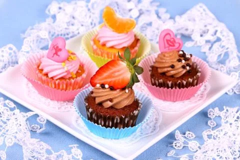 Assorted cup cakes with angel, heart, tangerine, strawberry Stock Photos