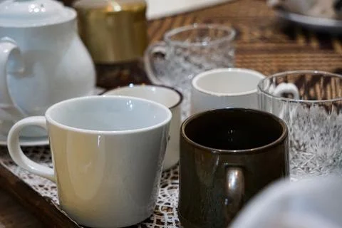 Assorted Cups And Mugs On Tray Stock Photos