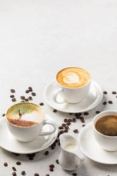 Assorted cups of coffee on the white background Stock Photos