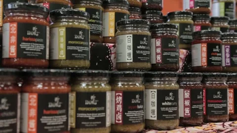 Assorted Curry Pastes and Sauces Displayed on Market Stall at Eveleigh Market Stock Footage 345803857