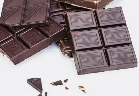 Assorted dark chocolate bars on white background Stock Photos