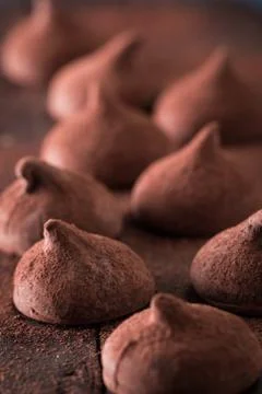 Assorted dark chocolate truffles with cocoa powder on dark blue table Stock Photos