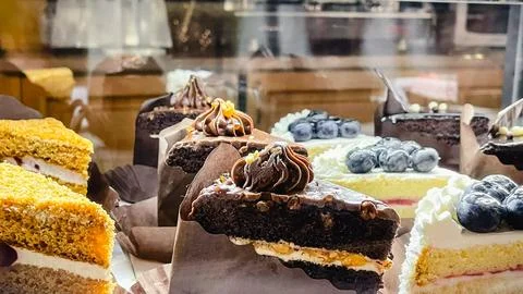 Assorted delicious cake slices including chocolate and blueberry cheesecake.. Stock Photos