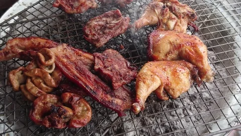 Assorted delicious grilled meat over the coals on a barbecue, top view Stock Footage 91902458