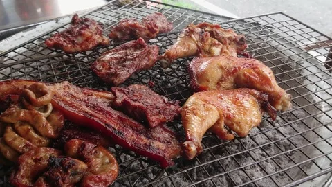 Assorted delicious grilled meat over the coals on a barbecue, top view Video stock 93034557