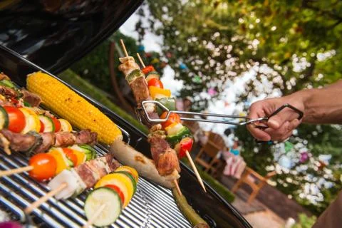 Assorted delicious grilled meat with vegetable over the coals on a barbecue Stock Photos