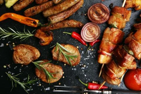 Assorted delicious grilled meat with vegetable on a barbecue Stock Photos