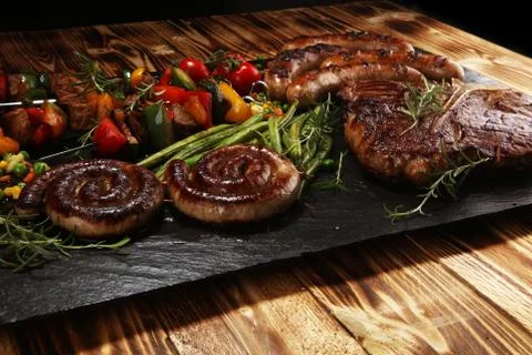 Assorted delicious grilled meat with vegetable on a barbecue Stock Photos
