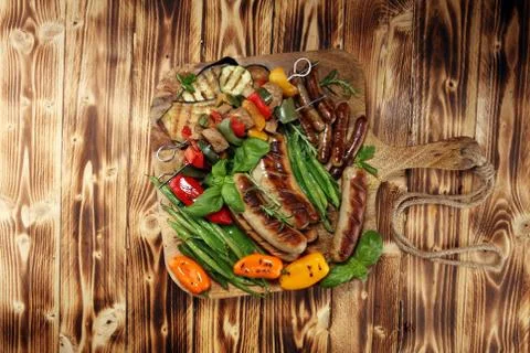 Assorted delicious grilled meat with vegetable on a barbecue. Grilled pork sh Stock Photos