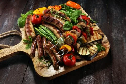 Assorted delicious grilled meat with vegetable on a barbecue. Grilled pork sh Stock Photos