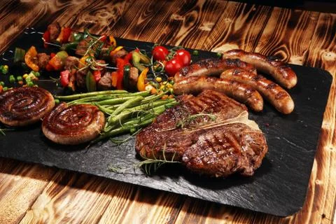 Assorted delicious grilled meat with vegetable on a barbecue Stock Photos