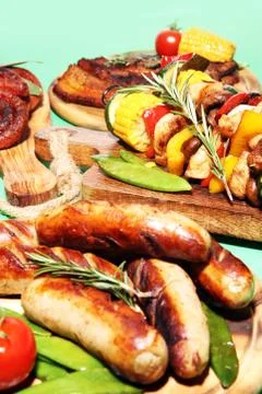Assorted delicious grilled meat with vegetable on rustic table Stock Photos