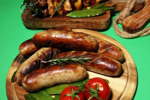 Assorted delicious grilled meat with vegetable on rustic table Stock Photos