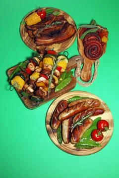 Assorted delicious grilled meat with vegetable on rustic table Stock Photos