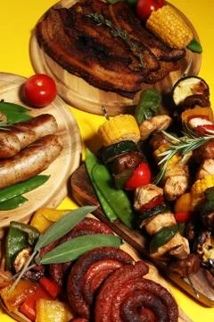 Assorted delicious grilled meat with vegetable on rustic table Stock Photos