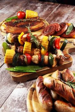 Assorted delicious grilled meat with vegetable on rustic table Stock Photos