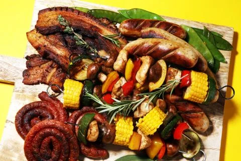 Assorted delicious grilled meat with vegetable on rustic table Stock Photos