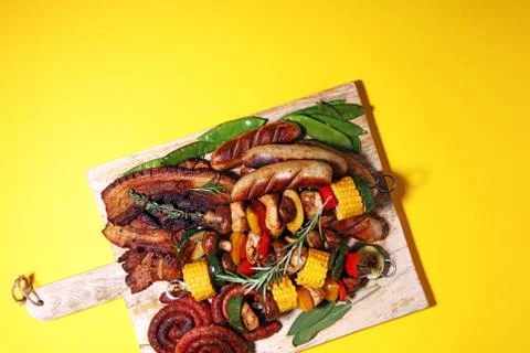 Assorted delicious grilled meat with vegetable on rustic table Stock Photos
