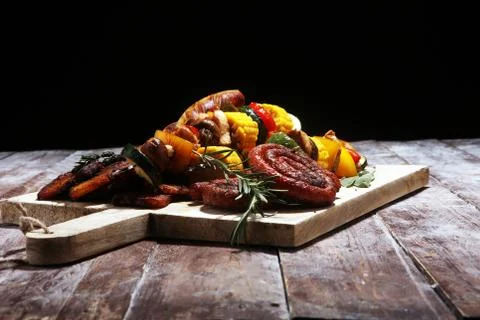 Assorted delicious grilled meat with vegetable on rustic table Stock Photos