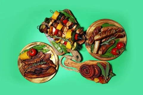 Assorted delicious grilled meat with vegetable on rustic table Stock Photos