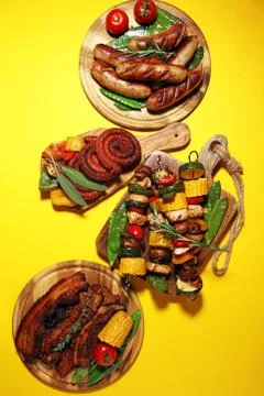 Assorted delicious grilled meat with vegetable on rustic table Stock Photos