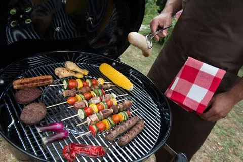 Assorted delicious grilled meat with vegetable on a barbecue Foto stock