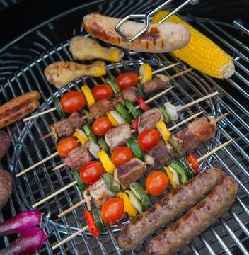Assorted delicious grilled meat with vegetable on a barbecue Stock Photos