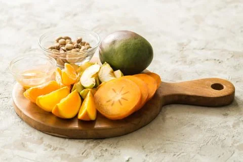 Assorted different fruits: persimmon, apple, oranges Stock Photos