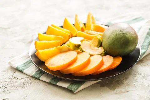 Assorted different fruits: persimmon, apple, oranges Stock Photos