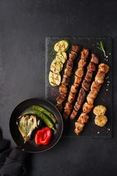 Assorted different kebabs on a black stone plate Stock-Fotos