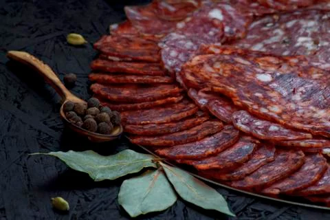 Assorted different types of cheese sausage on a dark background. Stock Photos