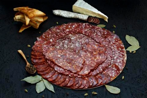 Assorted different types of cheese sausage on a dark background. Stock Photos