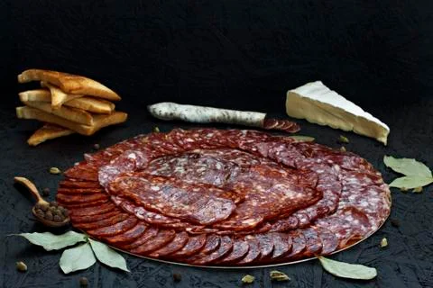 Assorted different types of cheese sausage on a dark background. Stock Photos