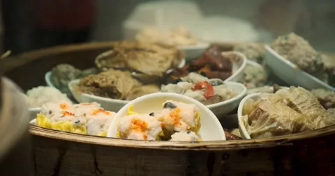 Assorted Dim Sum in a Smoky bamboo steamer Vidéo 132427848