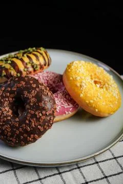 Assorted donuts on plate close angle Photos