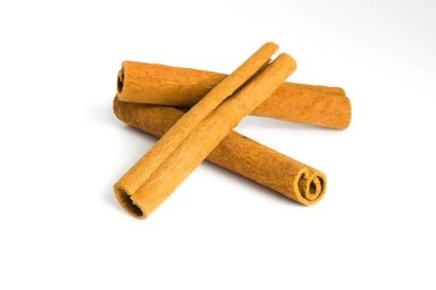 Assorted dried cinnamon bark pieces on white, focusing on their natural cur.. Stock Photos