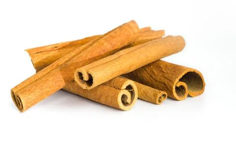 Assorted dried cinnamon bark segments laid out on white, revealing their in.. Stock Photos
