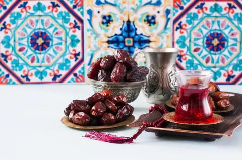 Assorted dried dates or kurma in a vintage plates and tea Stock Photos