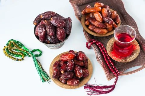 Assorted dried dates or kurma in a vintage plates and tea Stock Photos