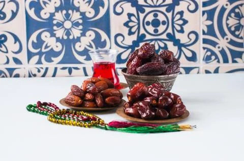 Assorted dried dates or kurma in a vintage plates and tea Stock Photos