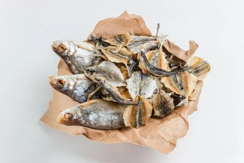Assorted dried fish in a basket on craft paper Stock-Fotos